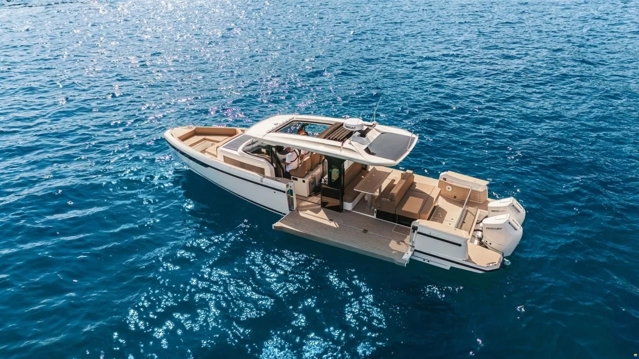 A white yacht seen from above on deep blue water